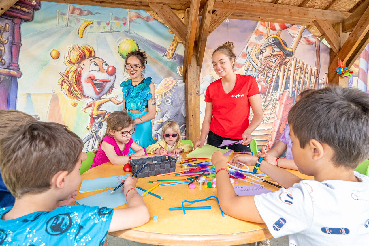 Enfants participant � une activit� cr�ative avec animateurs au camping CAPFUN Beauregard � MORNAS (84).