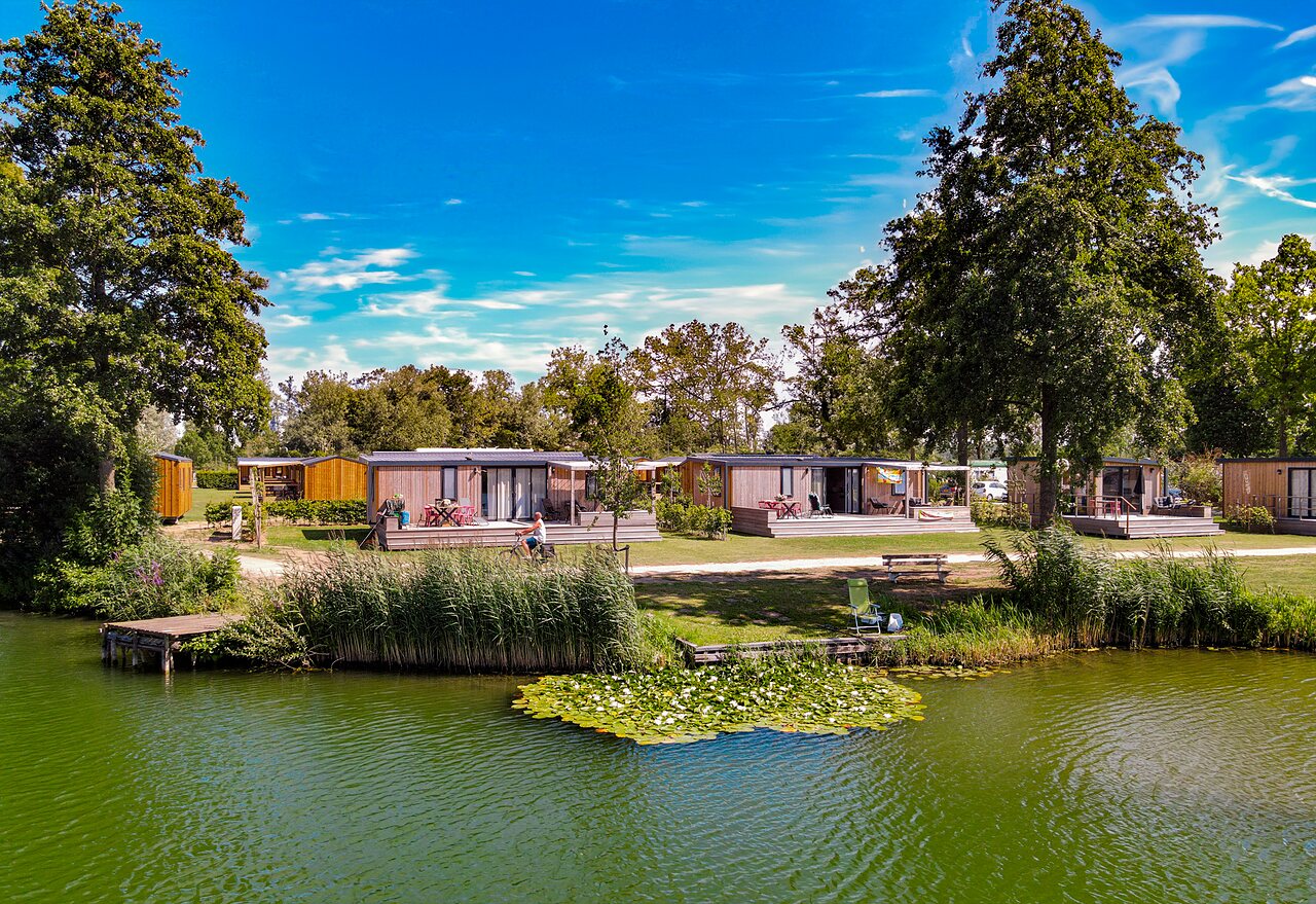 Mobil-homes modernes au bord d'un lac, verdure, au camping CAPFUN De Rotonde � Enspijk.