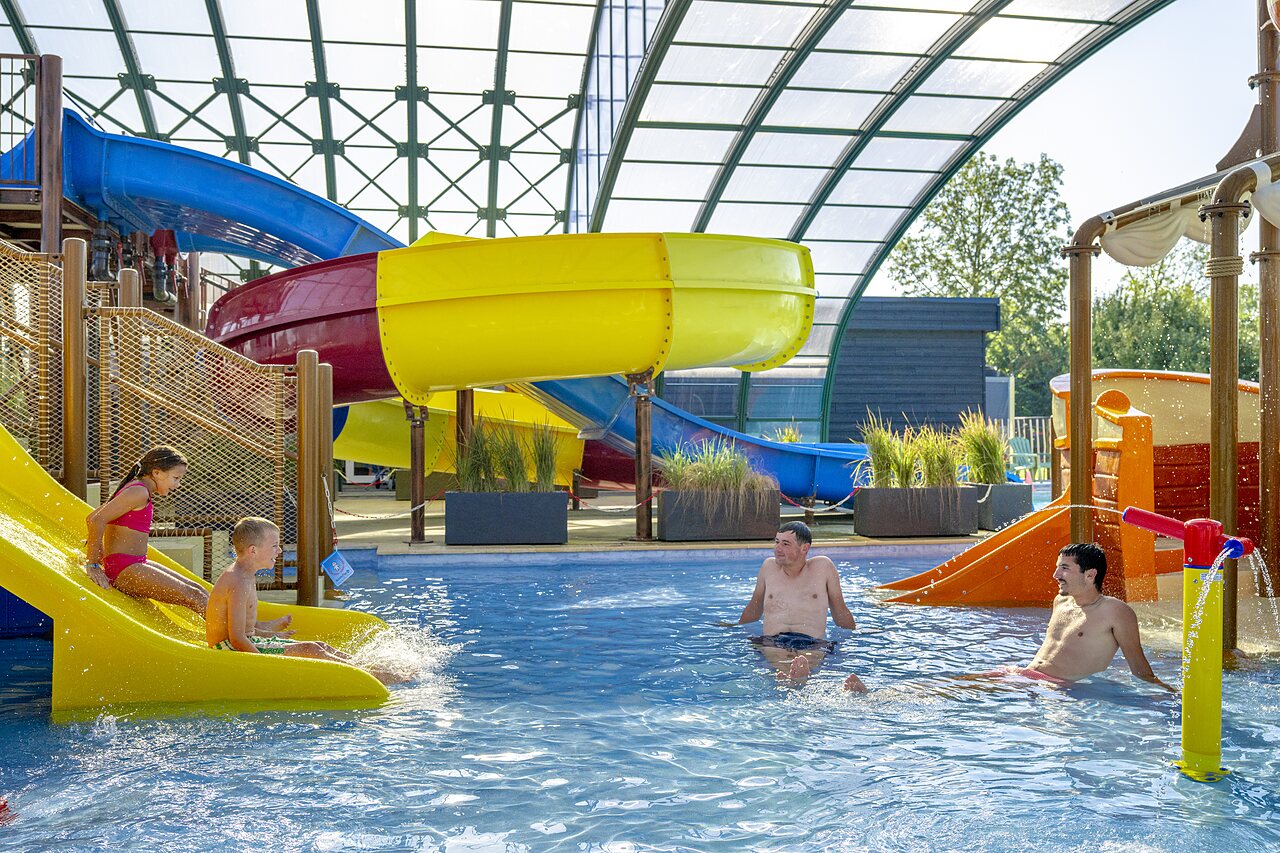 Piscine couverte avec toboggans et jeux d'eau au camping CAPFUN De Rotonde � Enspijk.