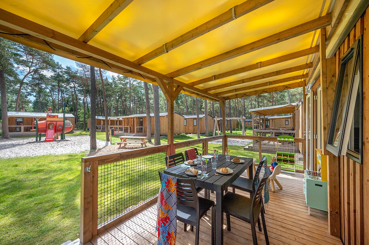 Terrasse am�nag�e d'un mobile-home avec aire de jeux au camping CAPFUN De Scheepsbel � Doornspijk.