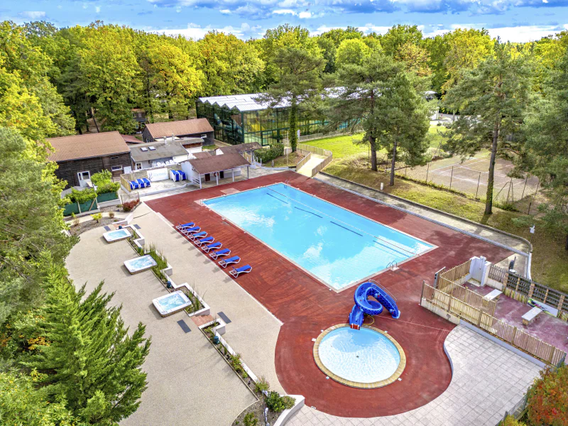 Outdoor swimming pool, waterslide, jacuzzis at CLICOCHIC La For�t d'Azal�e campsite.