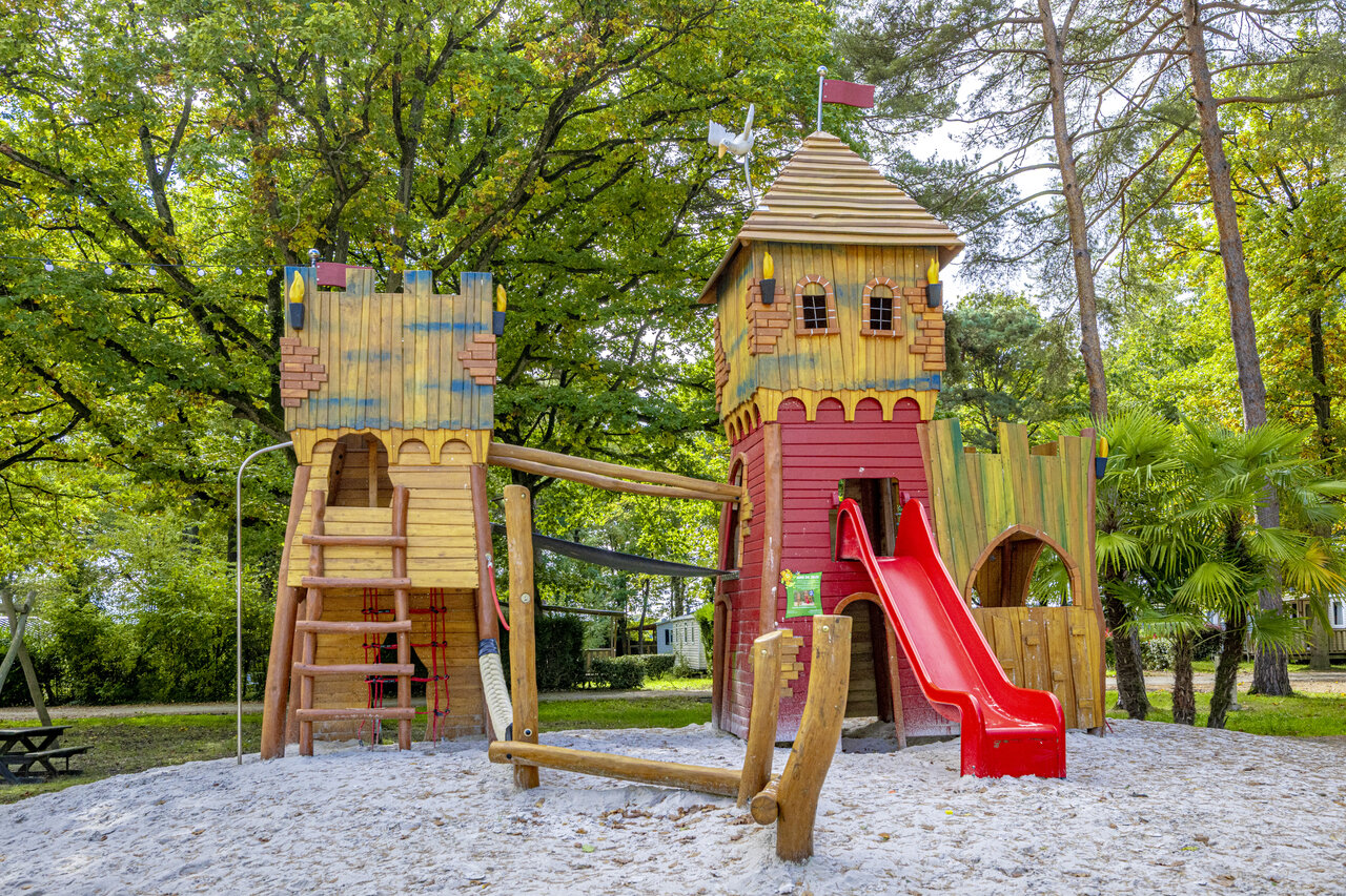 Wooden castle playground, slide, at camping CLICOCHIC La For�t d'Azal�e.