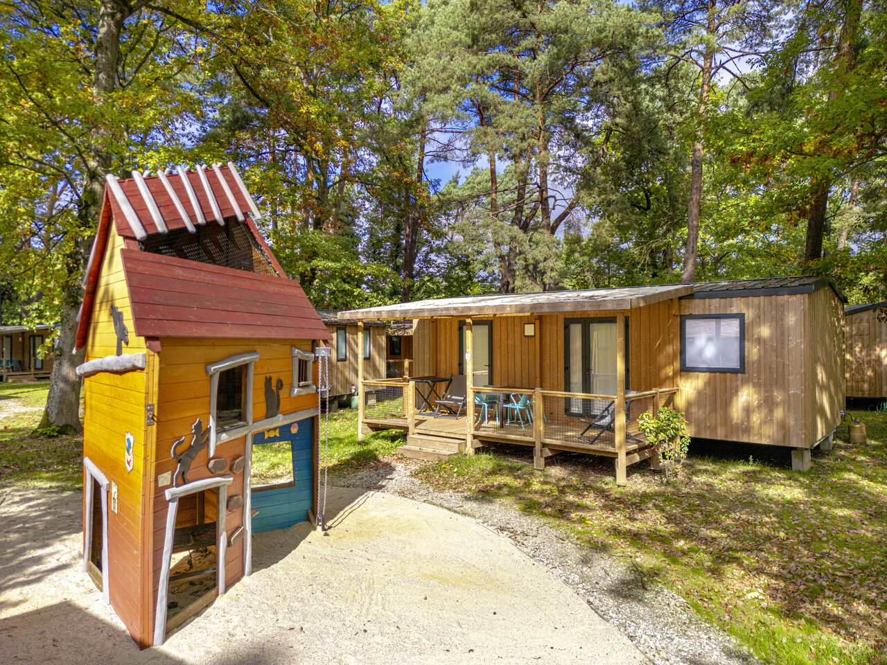 Wooden playhouse and mobile homes at CLICOCHIC La For�t d'Azal�e campsite.
