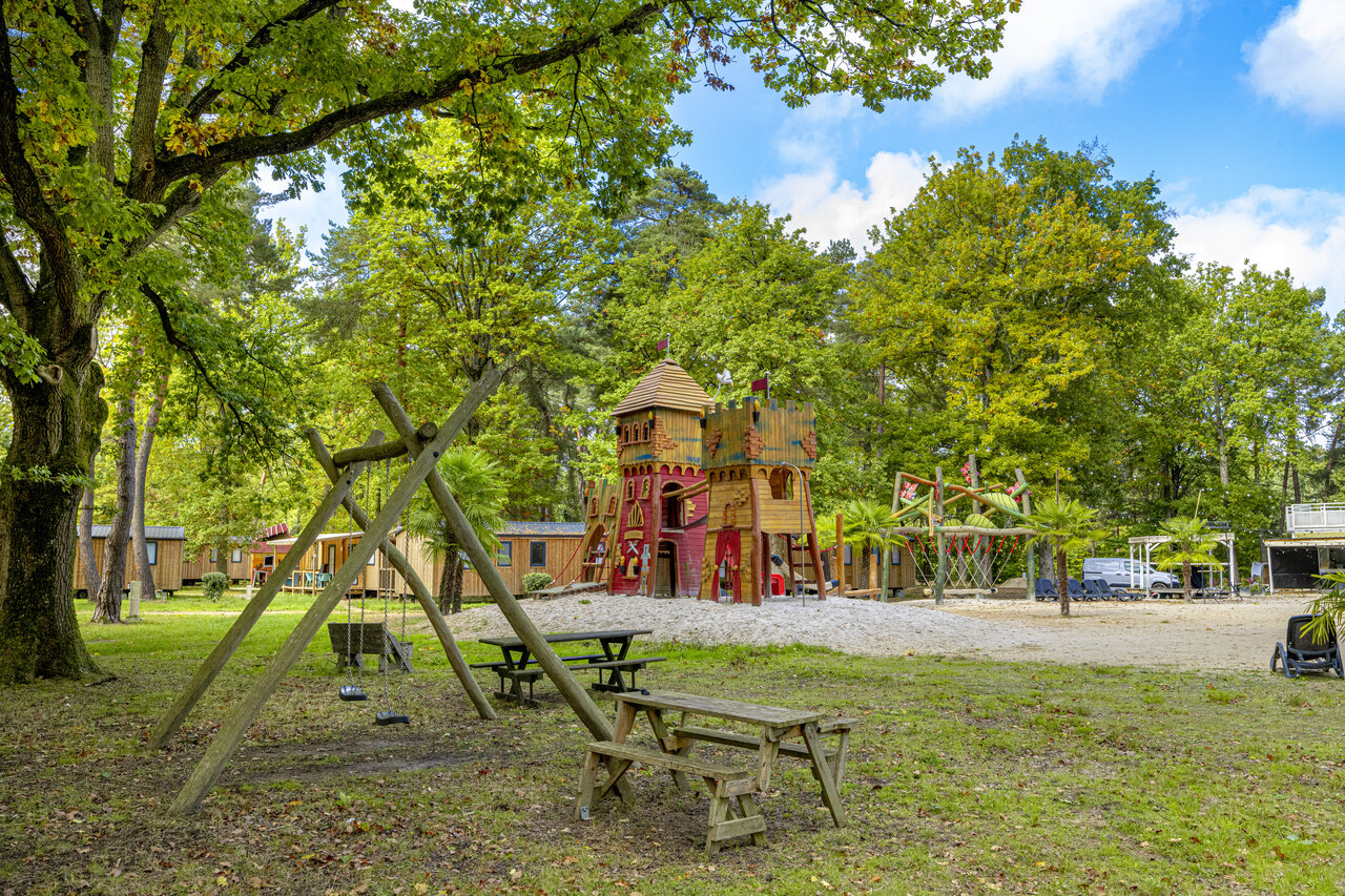 Play castle, swings for children at CLICOCHIC La For�t d'Azal�e campsite.