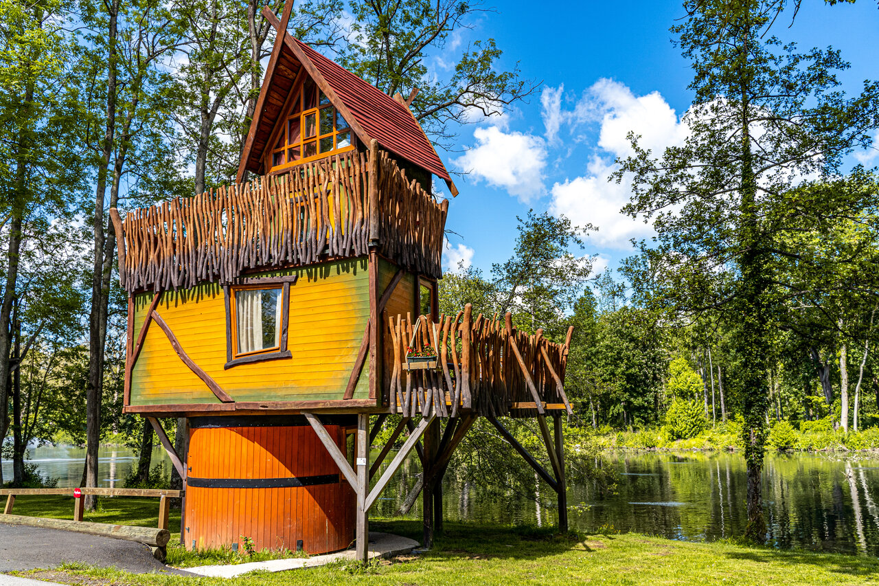 Colorful stilt cabin by a lake, CAPFUN Fredland campsite in Tournan en Brie.