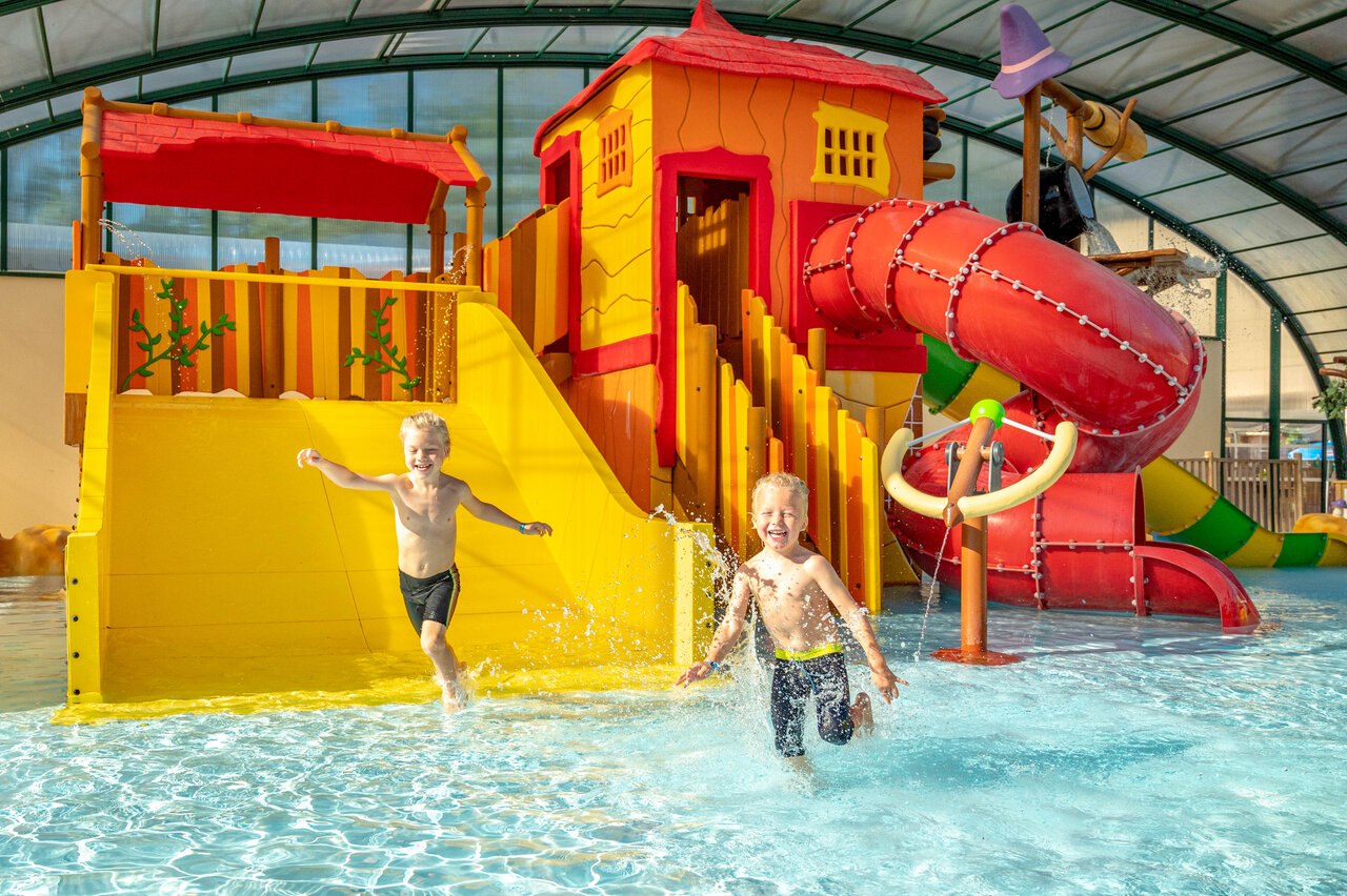 Kids enjoying water slide and play area at CAPFUN Fredland, Tournan en Brie (77).