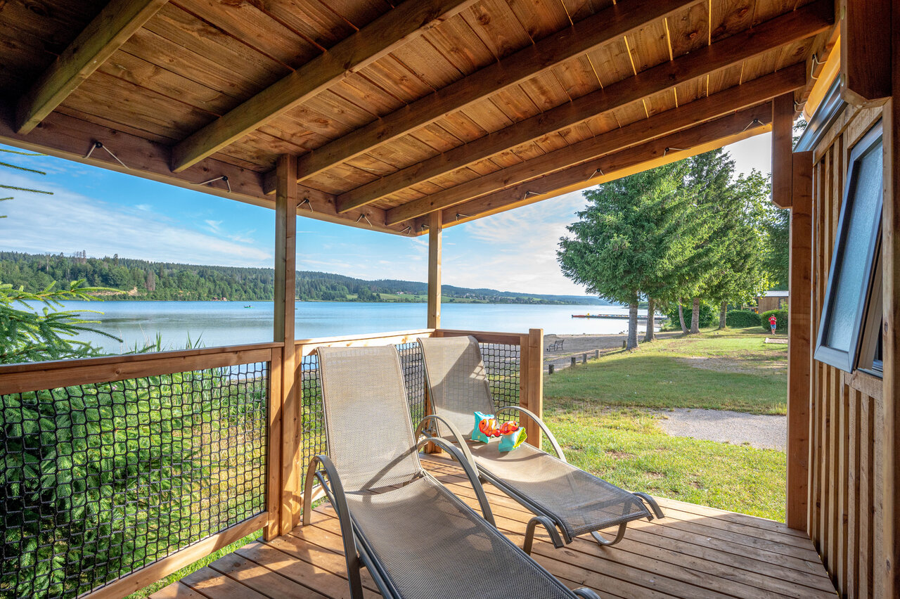 Terrasse d'h�bergement avec transats et vue lac au camping CAPFUN Fuvettes � Malbuisson (25).
