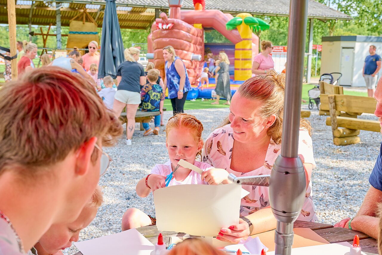 Famille jouant � la p�tanque pr�s d'une aire de jeux au camping CAPFUN Heino � Heino.
