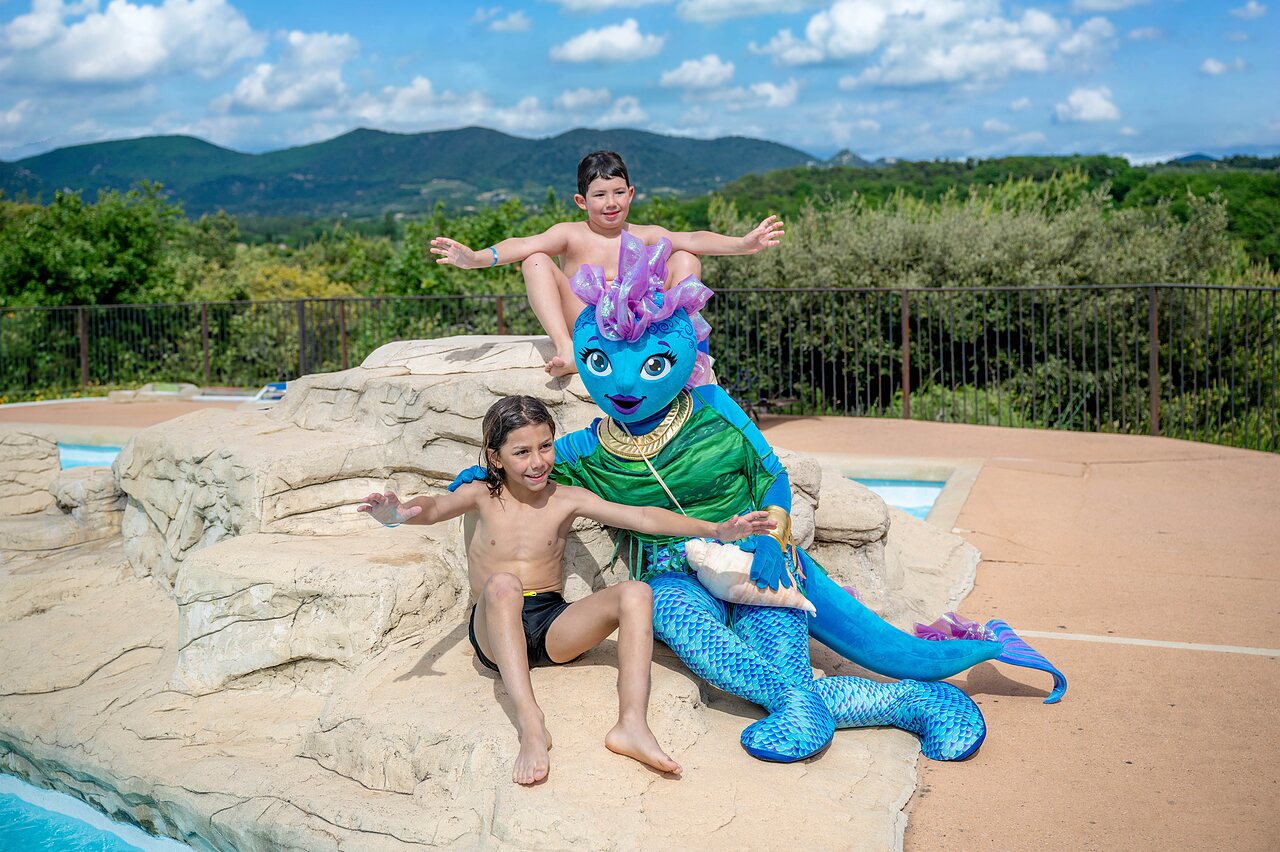 Mascotte et enfants � la piscine du camping VAGUES OCEANES Soleil de Provence (84).