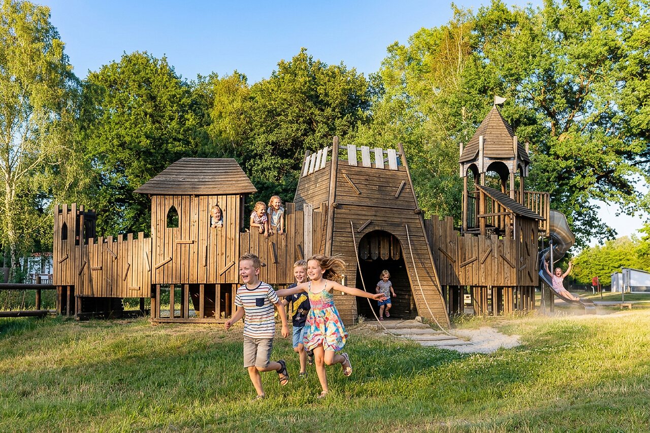 Enfants jouant sur une grande aire de jeux en bois au camping CAPFUN Tecklenburg � Tecklenburg-Leeden (49).