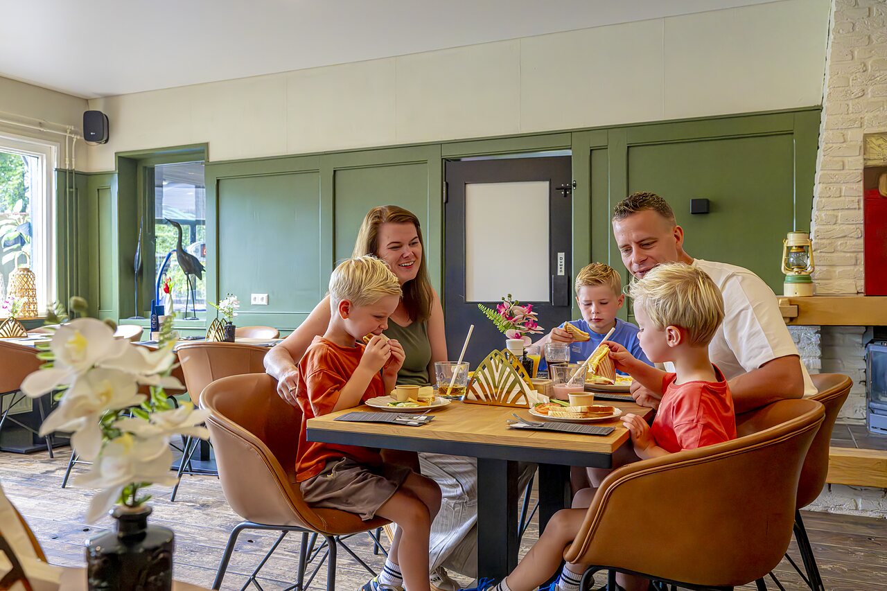 Famille d�jeunant au restaurant du camping CAPFUN Vlinderloo � Enschede.