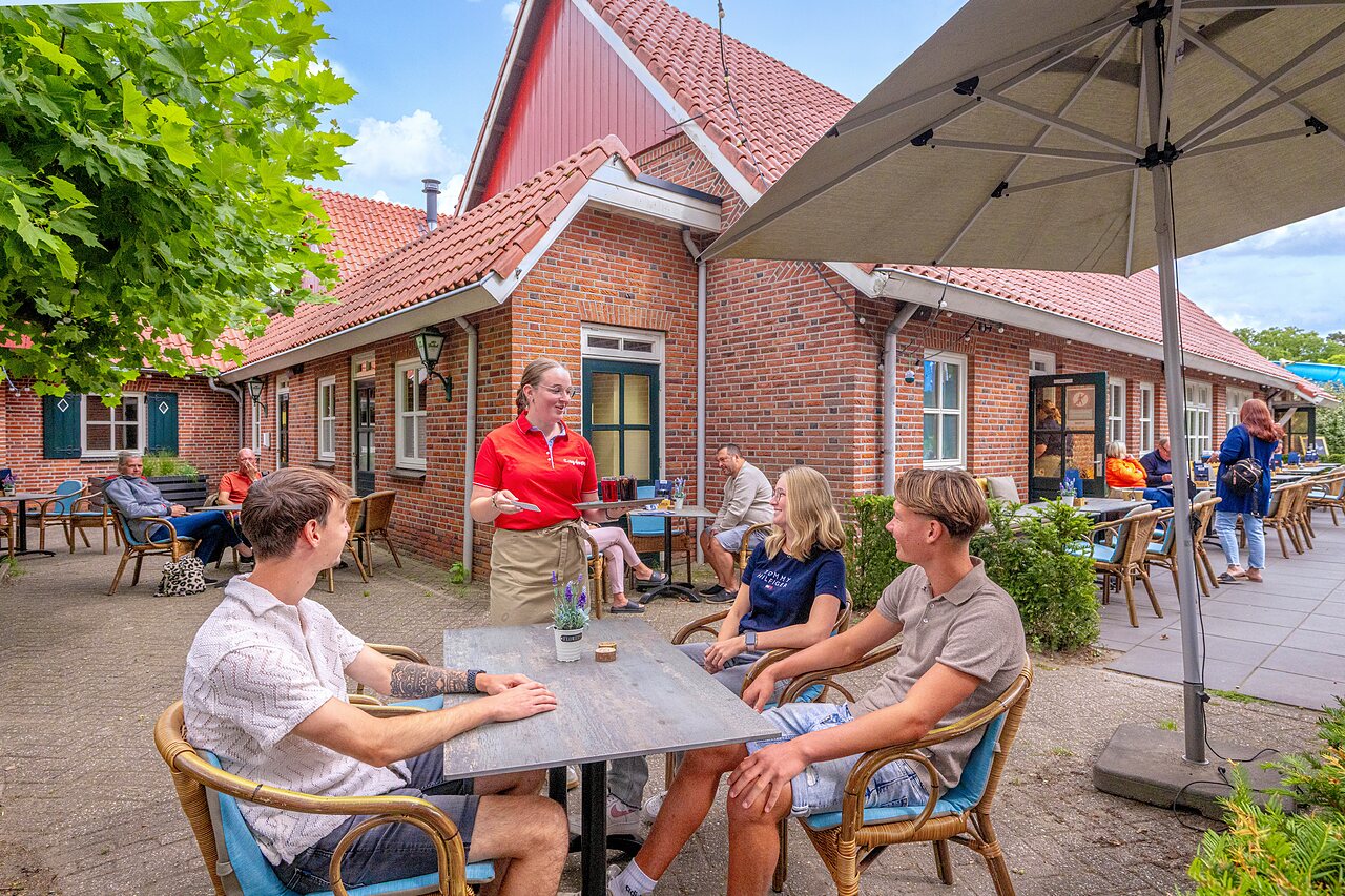 Levendig restaurantterras, drankenservice op camping CAPFUN het Winkel in Winterswijk.